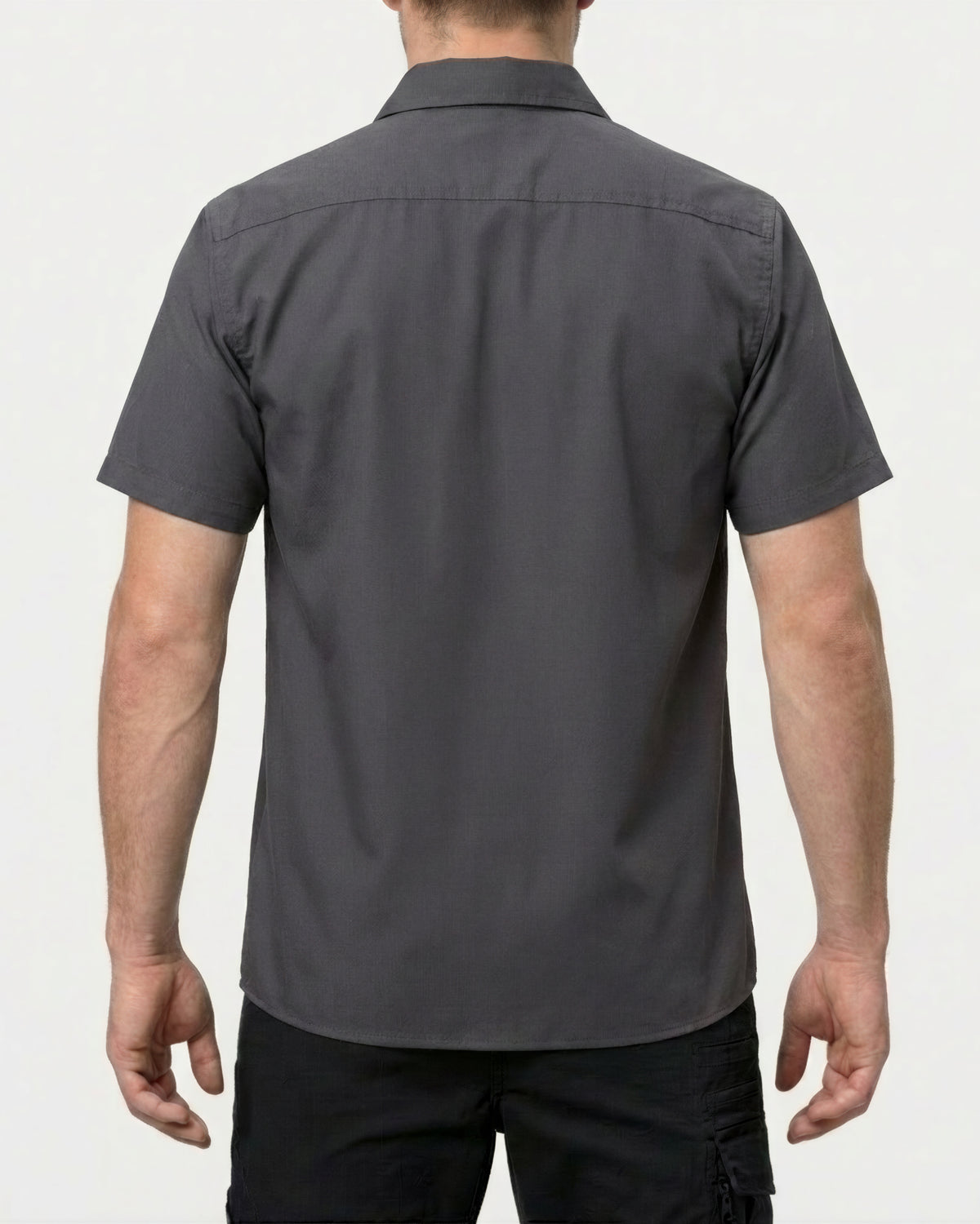 A model wears the STRAUSS Short Sleeve Work Shirt e.s.iconic in carbon gray with work pants