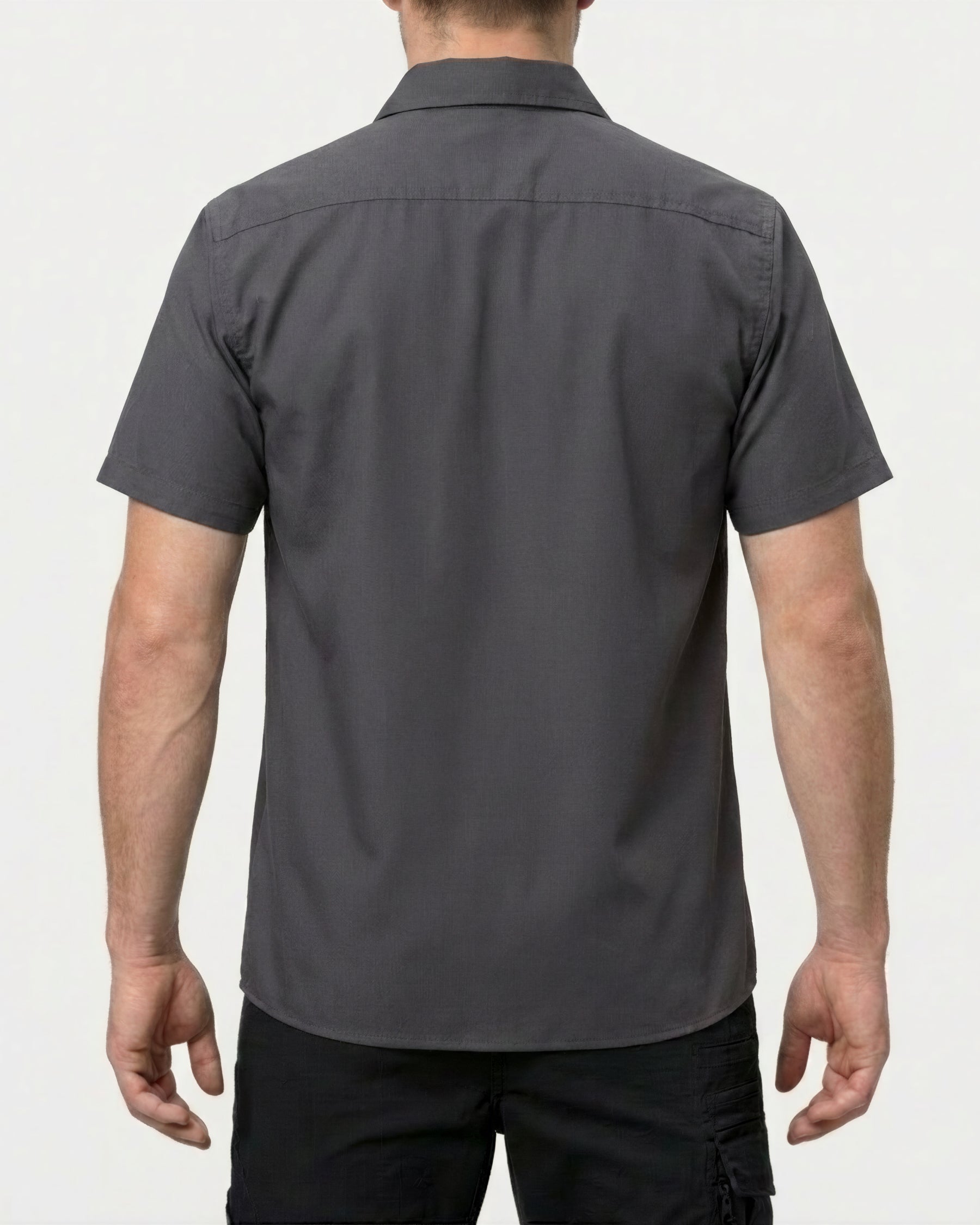 A model wears the STRAUSS Short Sleeve Work Shirt e.s.iconic in carbon gray with work pants