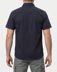 A model wears the STRAUSS Short Sleeve Work Shirt e.s.iconic in nero blue with work pants, showing the shirt fit