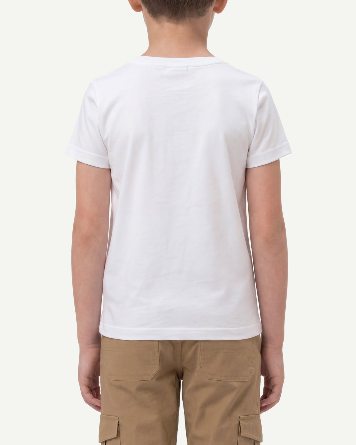 A child wears the Kids' STRAUSS Cotton Stretch T-Shirt in white with casual workwear pants, showing the shirt fit