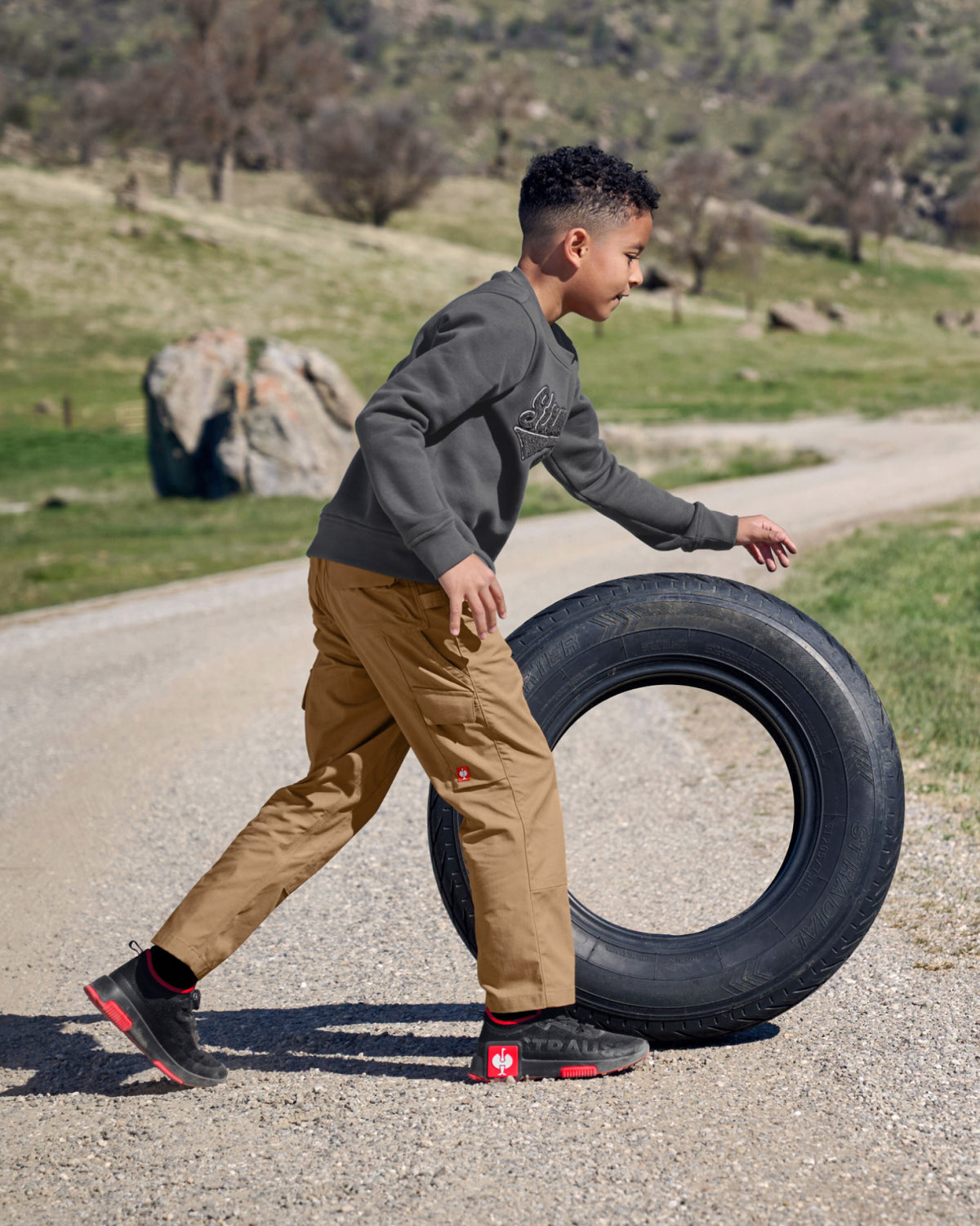 Kids' STRAUSS e.s.e:pic artwork crew neck sweatshirt in carbon gray, worn in workwear outfit