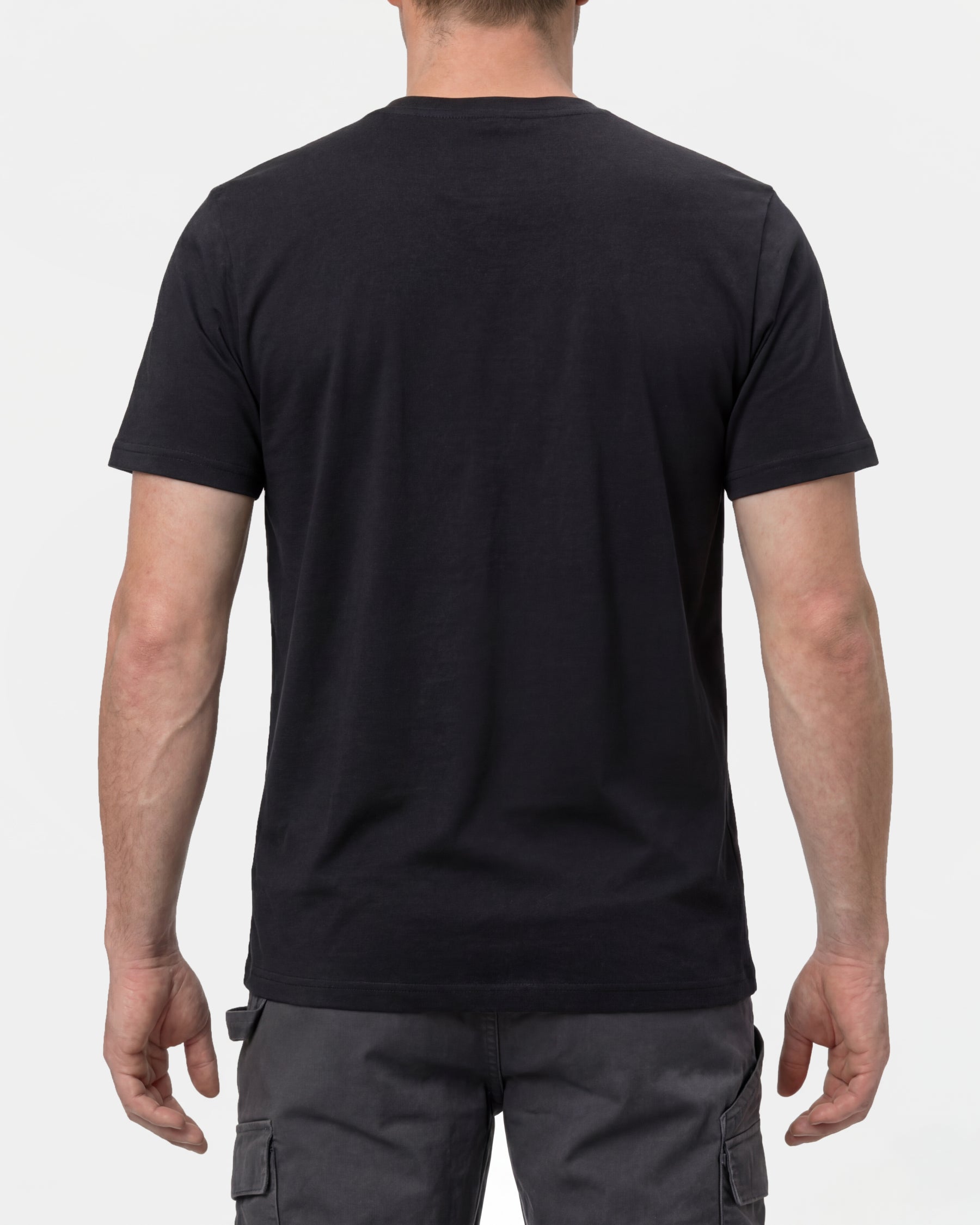 A model wears the STRAUSS T-Shirt e.s.concrete in black with work pants and work boots, showing the shirt fit
