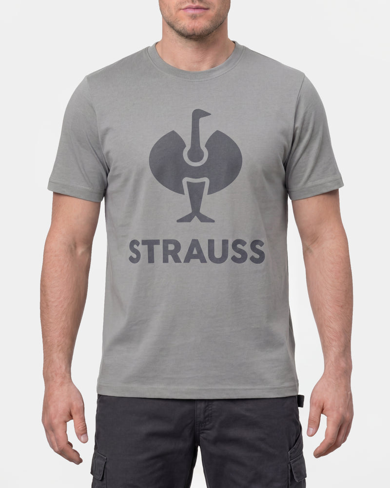 A model wears the STRAUSS T-Shirt e.s.concrete in pearl gray with work pants and work boots in a studio product scene