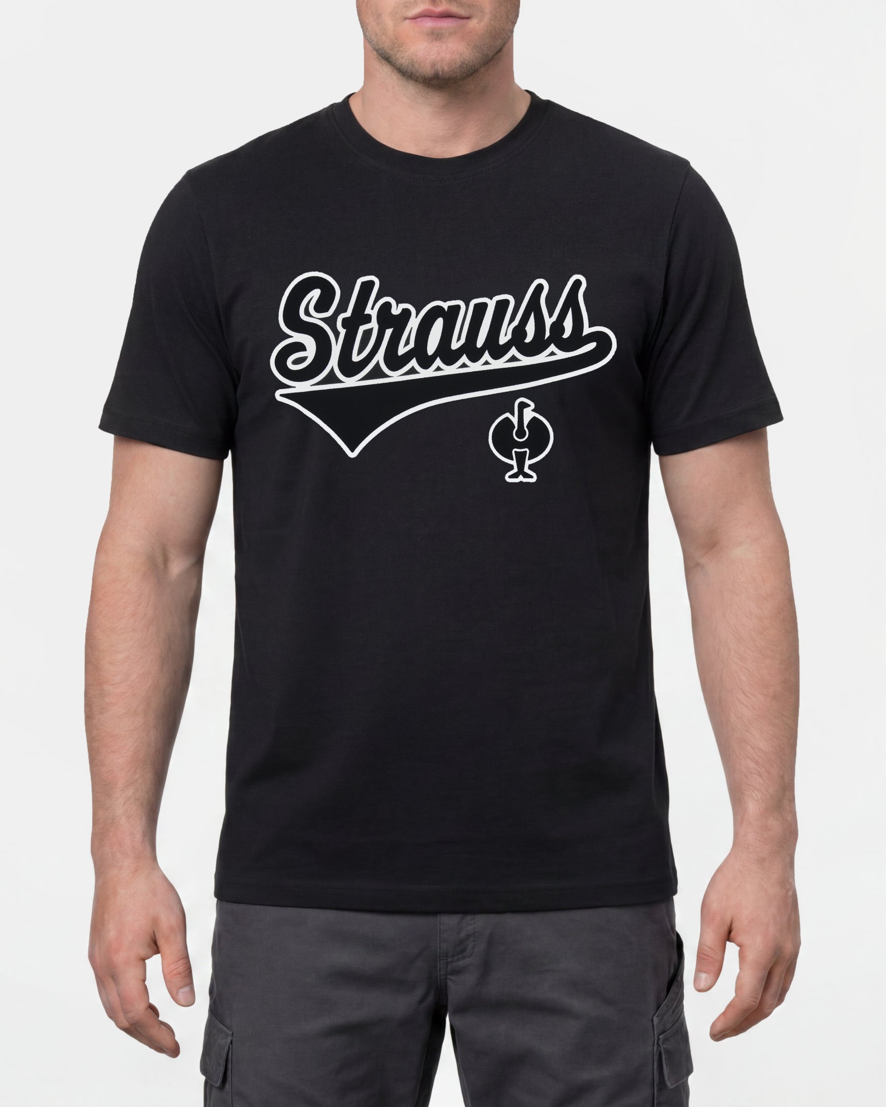 A model wears the STRAUSS Artwork T-Shirt e.s.e:pic in black with work pants and work boots in a studio product scene
