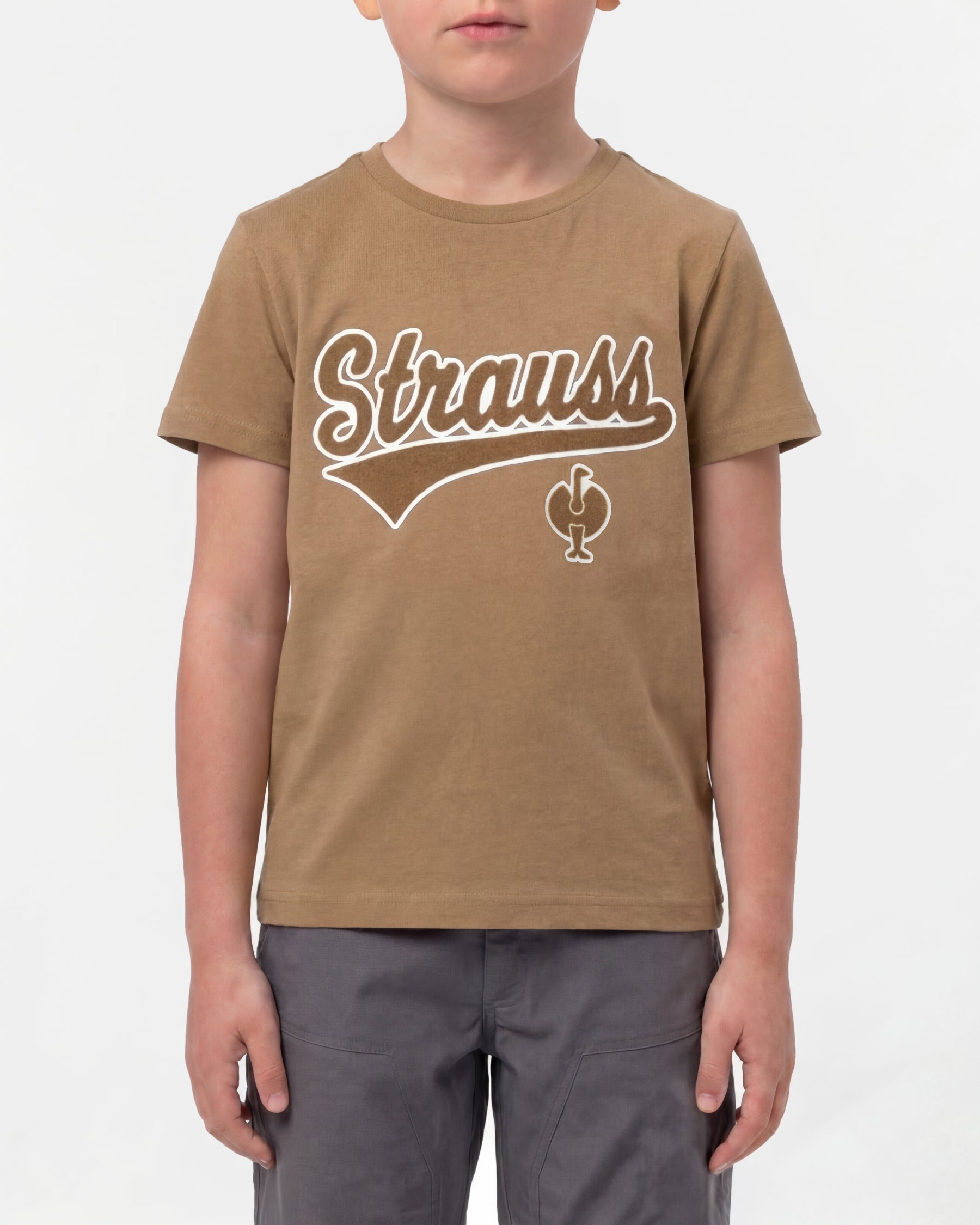 A child wears the Kids' STRAUSS Artwork T-Shirt e.s.e:pic in almond brown with casual workwear pants in a studio product scene