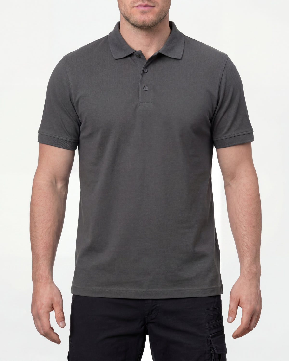 A model wears the STRAUSS Cotton Stretch Polo Shirt in carbon gray with tan work pants and work boots in a studio product scene