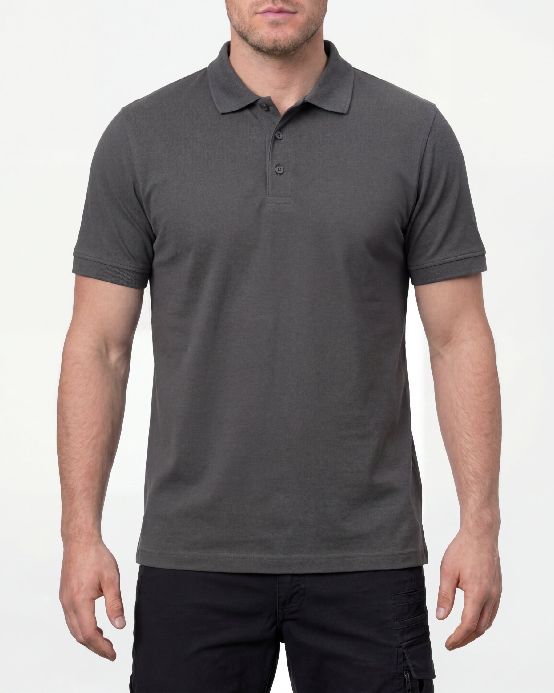 A model wears the STRAUSS Cotton Stretch Polo Shirt in carbon gray with tan work pants and work boots in a studio product scene