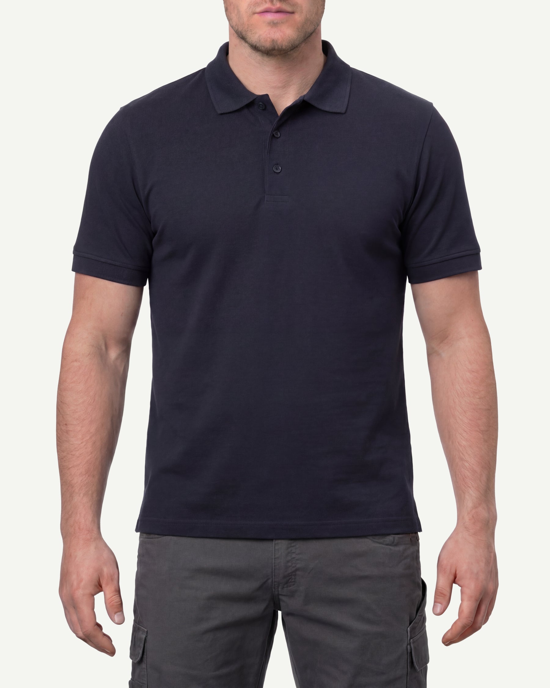 A model wears the STRAUSS Cotton Stretch Polo Shirt in nero blue in a studio product scene