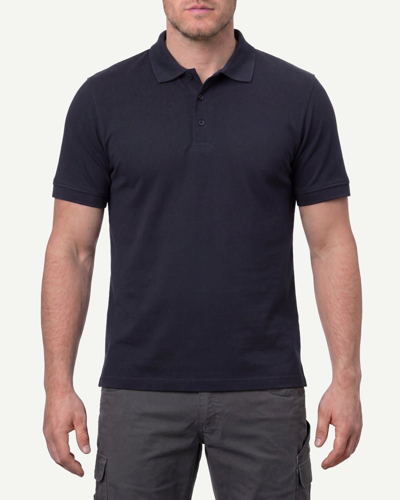 A model wears the STRAUSS Cotton Stretch Polo Shirt in nero blue in a studio product scene