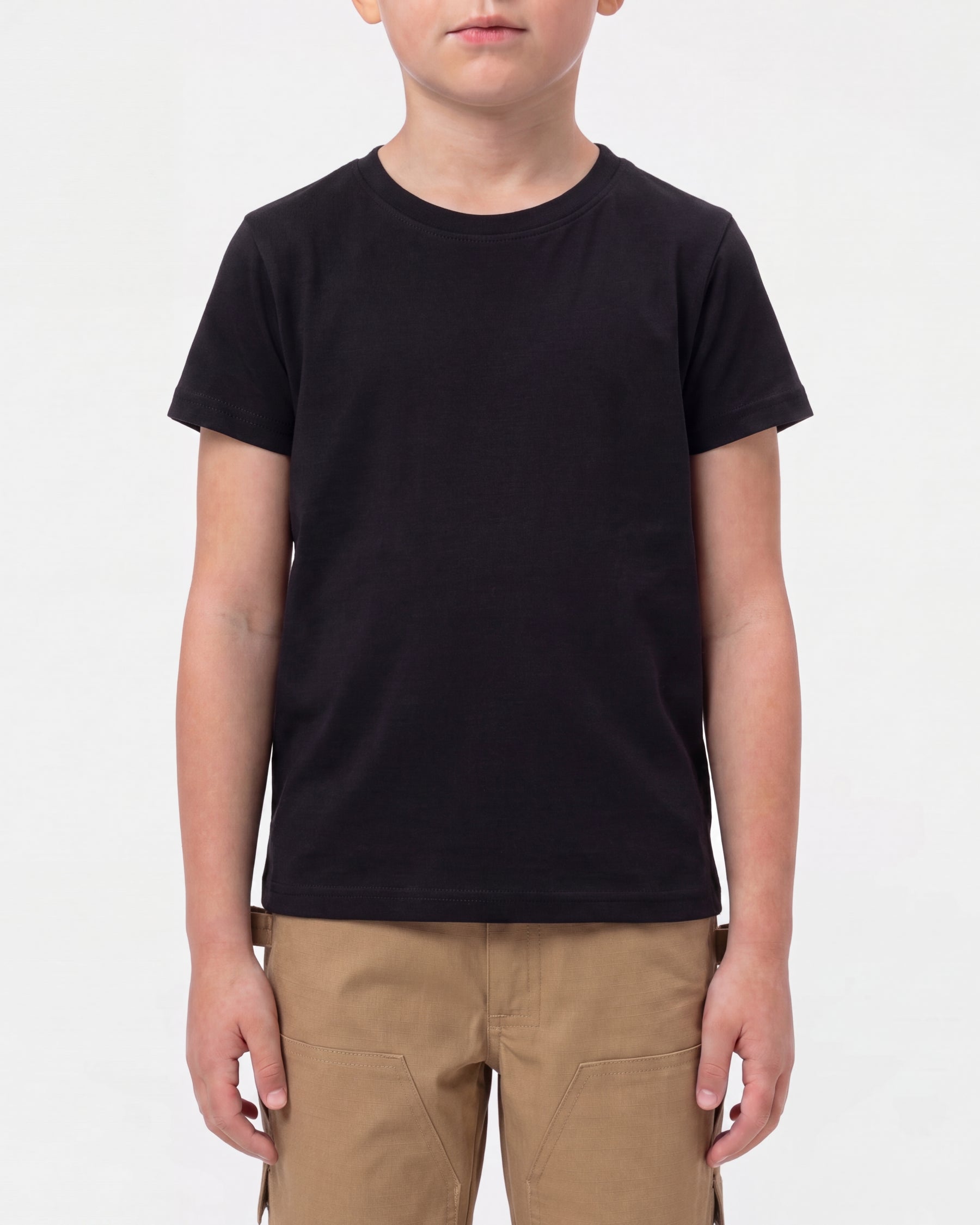 A child model wears the Kids' STRAUSS Cotton Stretch T-Shirt in black with kids' work pants and work boots in a studio product scene