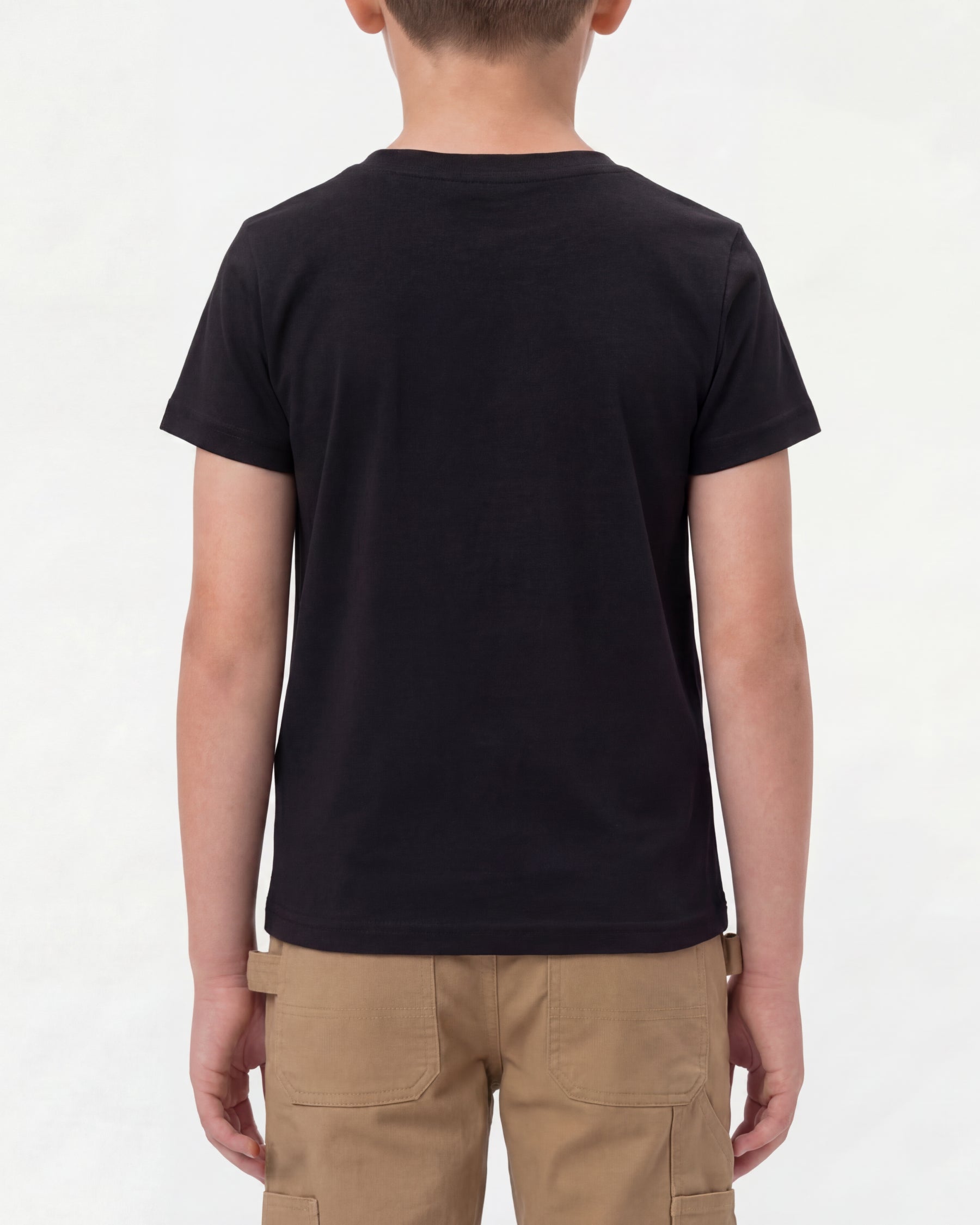 A child wears the Kids' STRAUSS Cotton Stretch T-Shirt in black with kids' work pants and work boots, showing the shirt fit