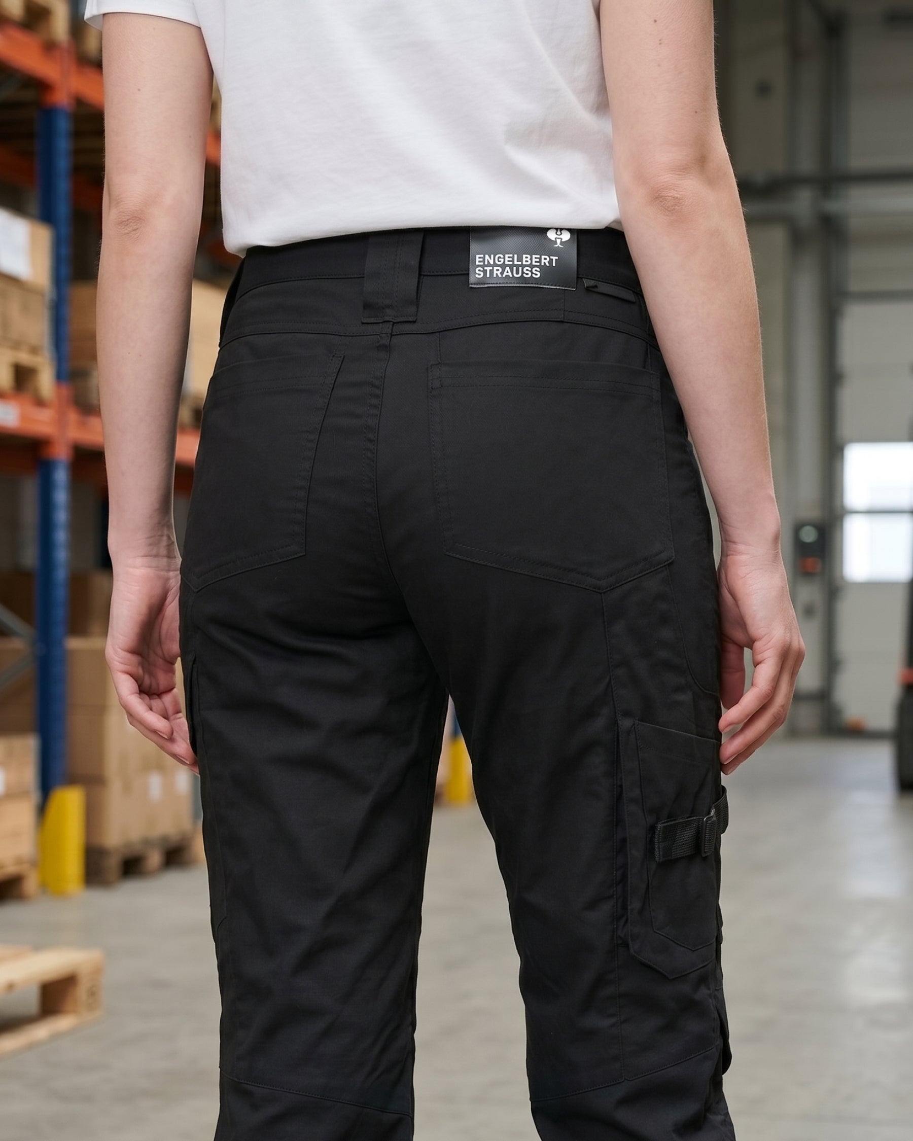 Women's Work Pants e.s.concrete light in black shown in an outdoor workwear setting