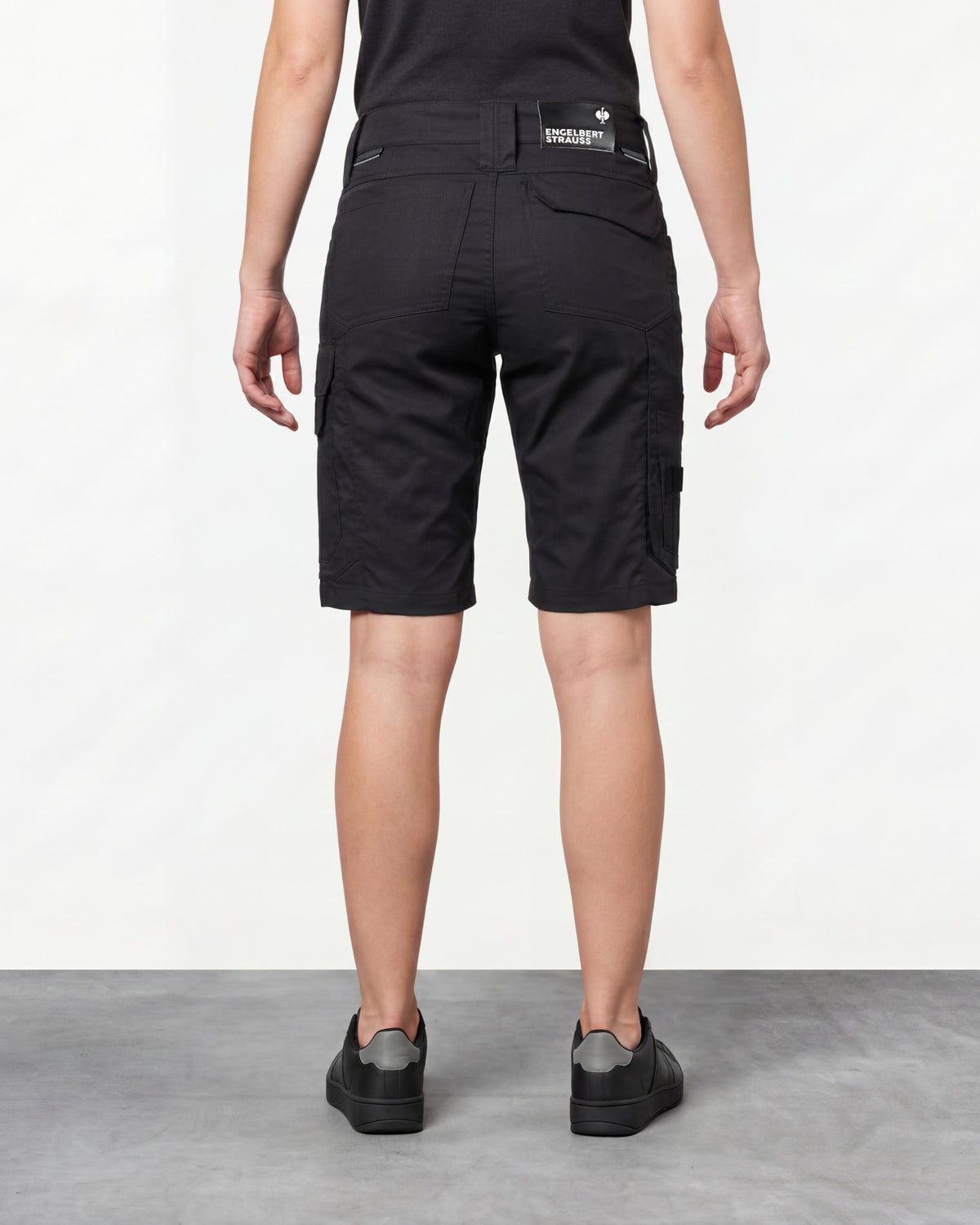 Alternate model view of Engelbert Strauss women's e.s. concrete light shorts in black, showing the side and back fit with visible utility pocket placement and workwear construction.