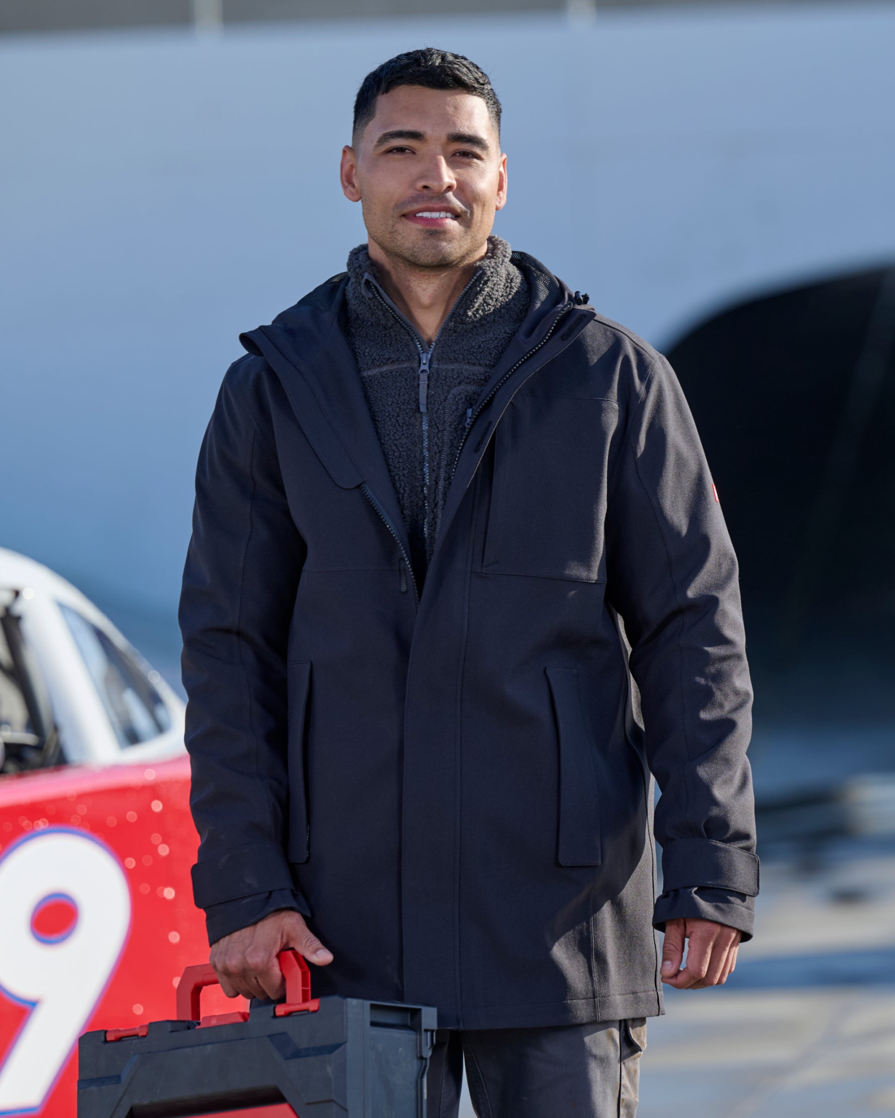 STRAUSS e.s.e:pic waterproof rain coat in black in use on the job