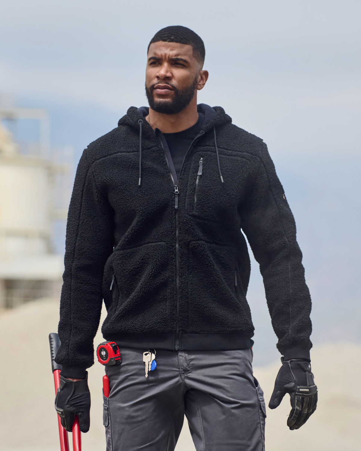 STRAUSS e.s.e:pic hooded sherpa fleece jacket in black worn in a work setting