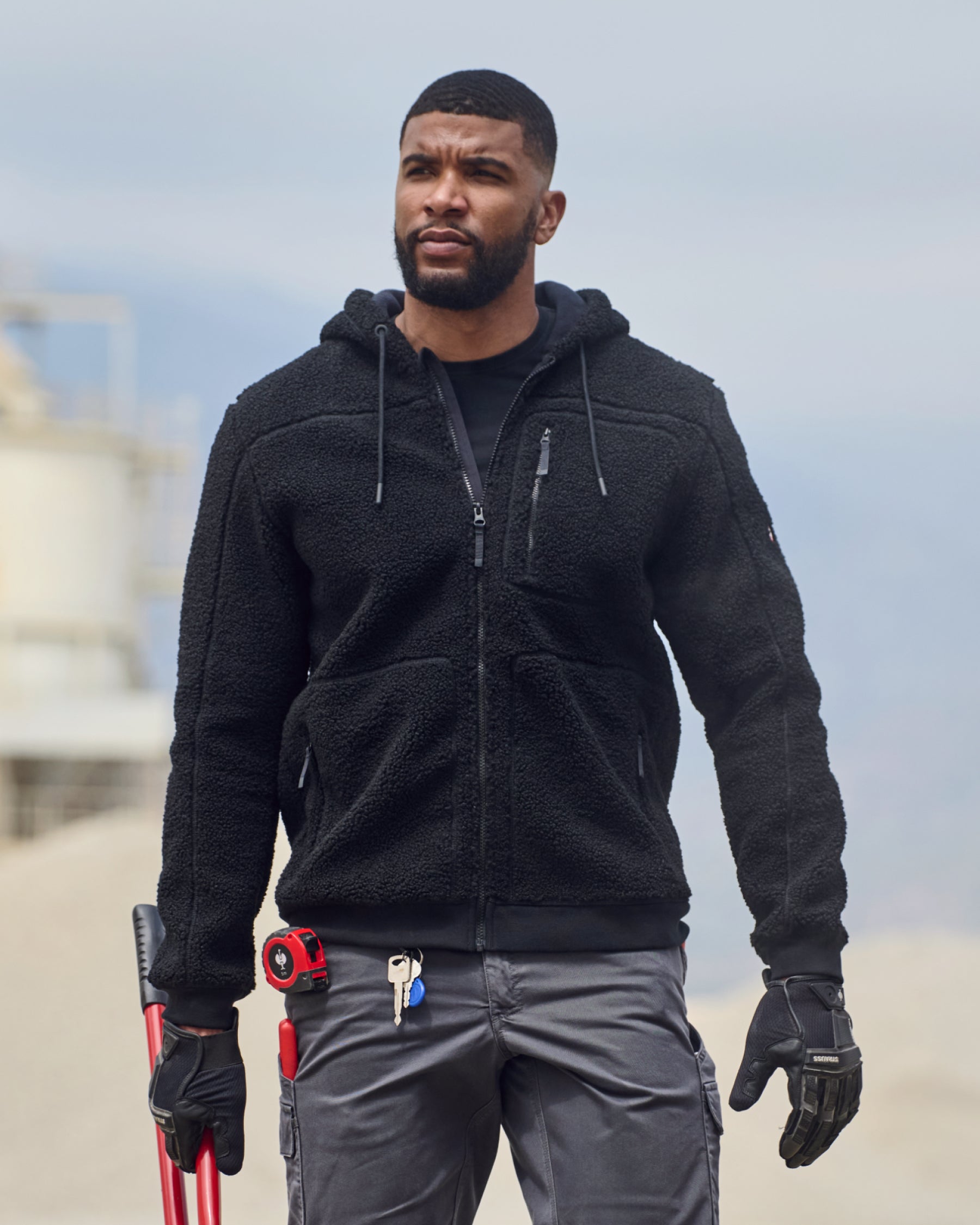 STRAUSS e.s.e:pic hooded sherpa fleece jacket in black worn in a work setting