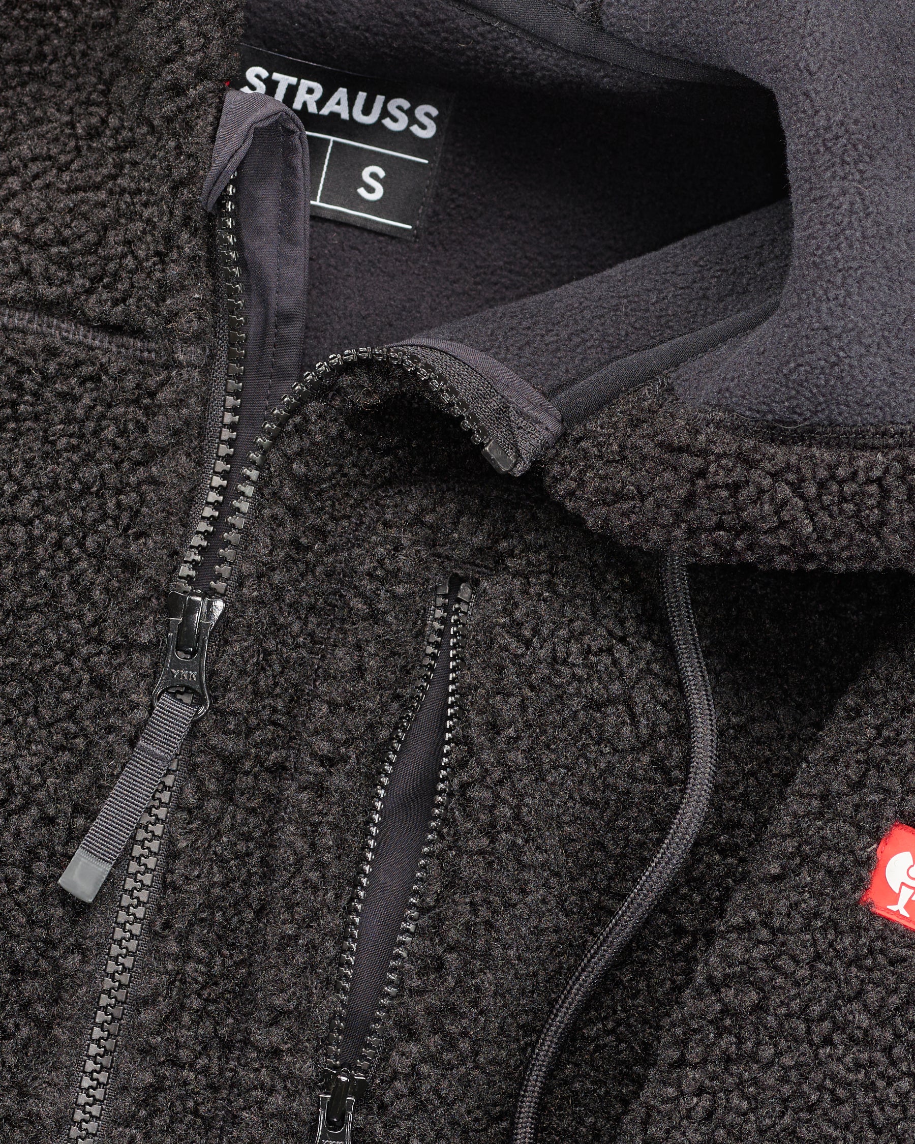Close-up of sherpa fleece texture and hood details on STRAUSS e.s.e:pic hooded sherpa fleece jacket in black