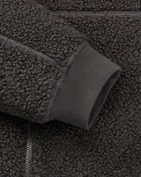 Close-up of zippered pocket details on STRAUSS e.s.e:pic hooded sherpa fleece jacket in black