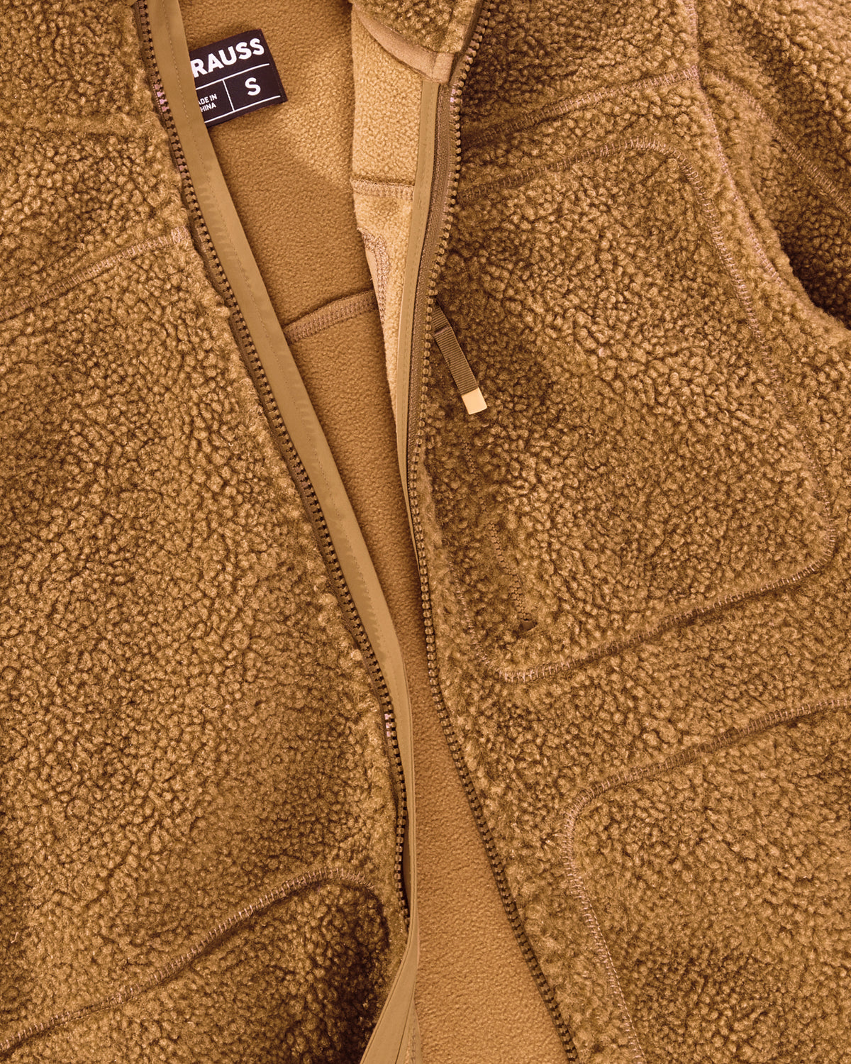Close-up of sherpa fleece texture and collar details on STRAUSS e.s.e:pic sherpa fleece jacket in almond brown