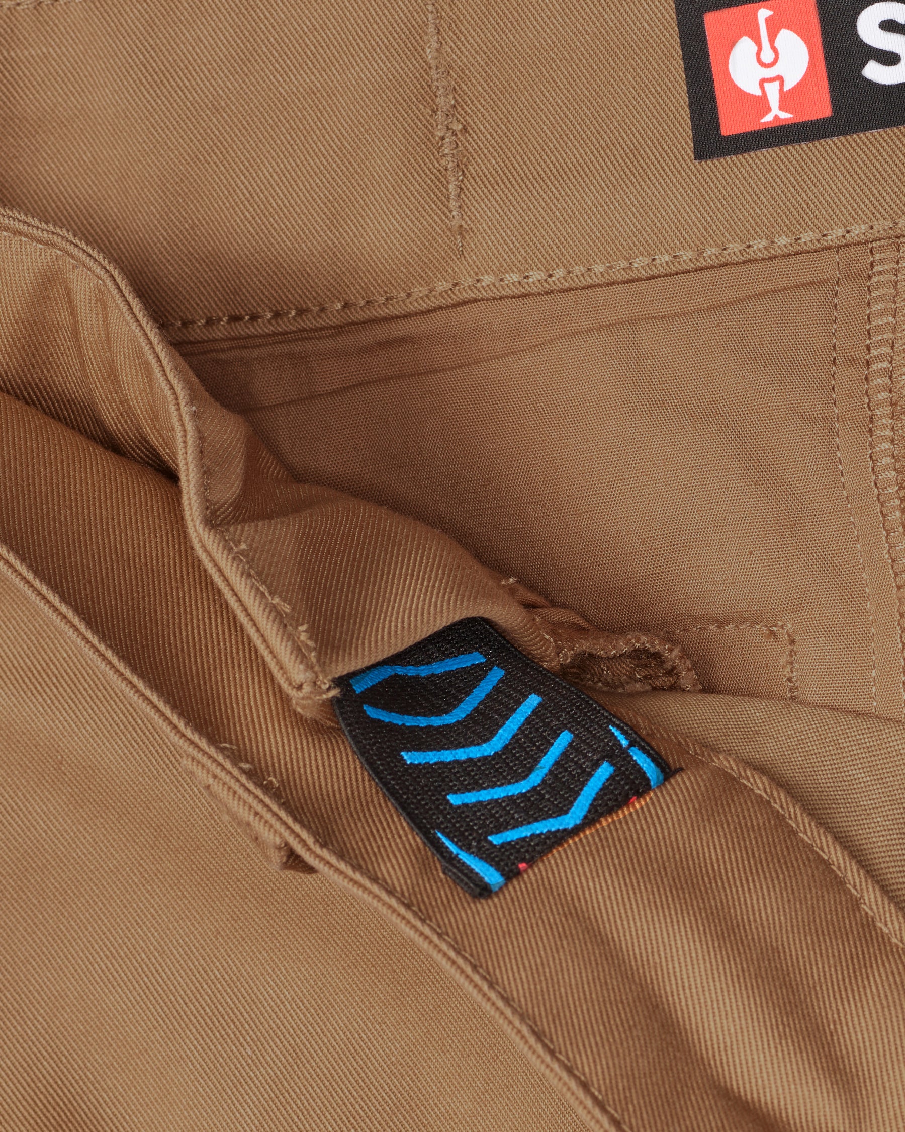 Close-up of chino pocket and waistband on Chino Pants e.s.e:pic in almond brown