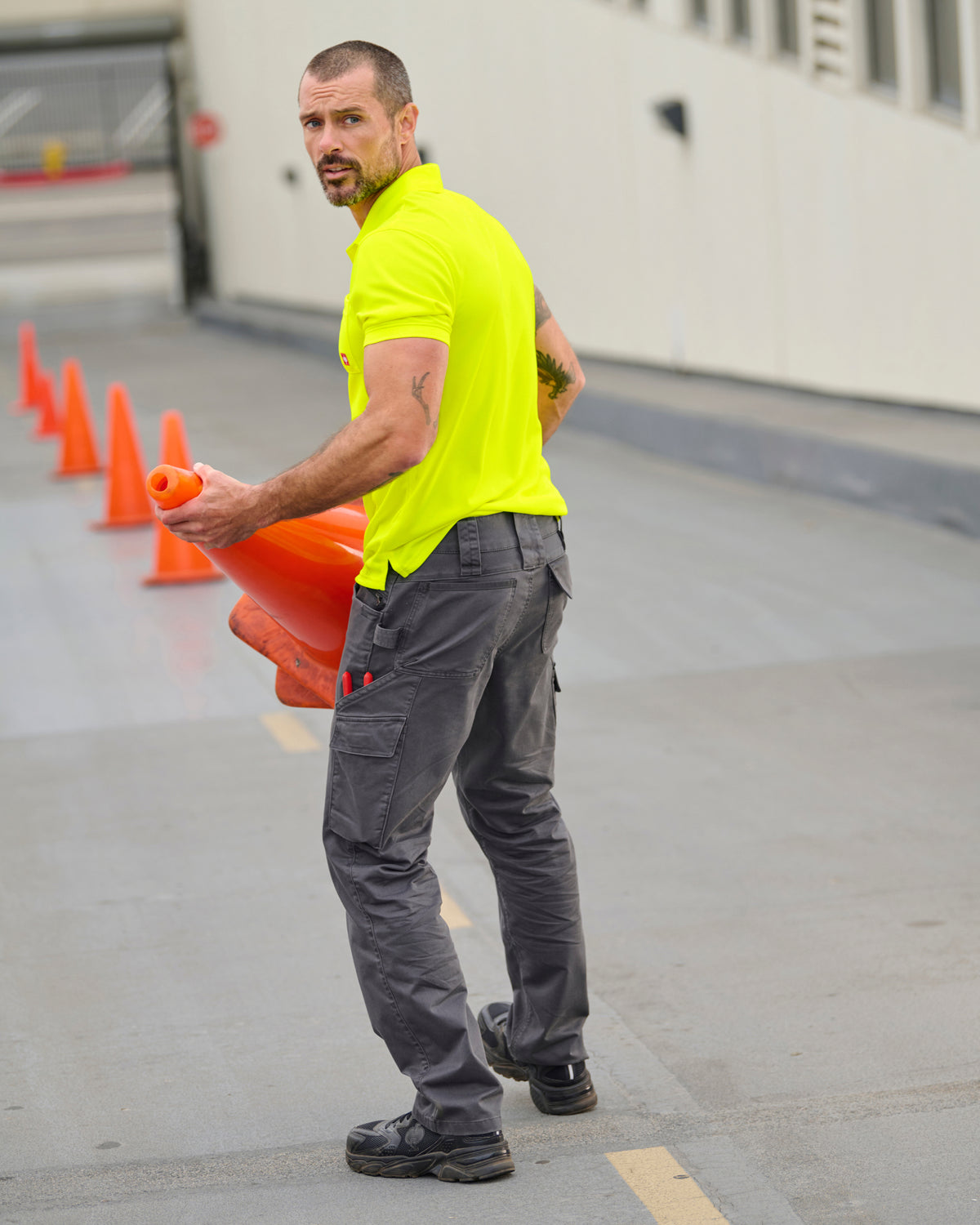 Lifestyle view of Twill Cargo Work Pants e.s.e:pic in carbon gray during work