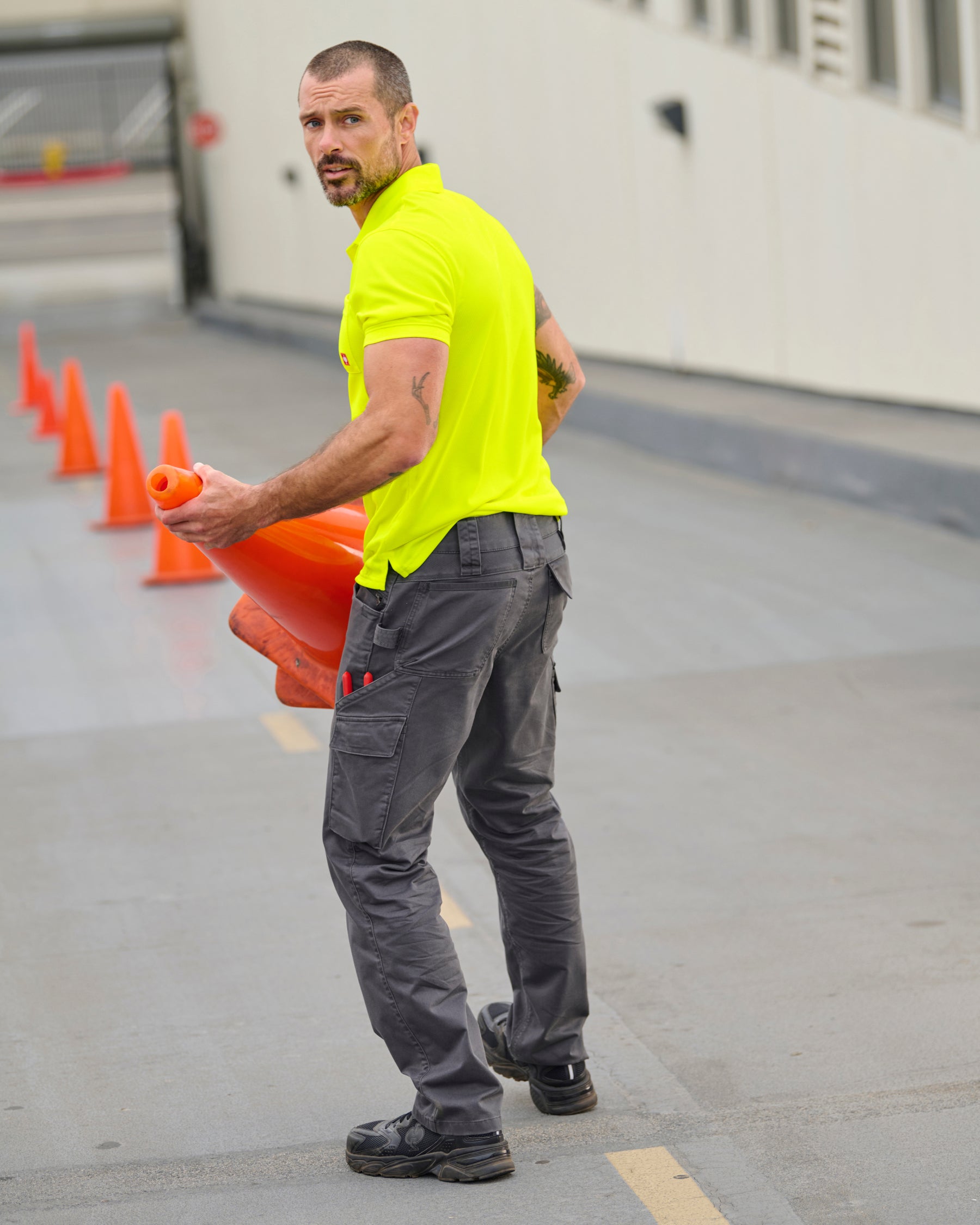 Lifestyle view of Twill Cargo Work Pants e.s.e:pic in carbon gray during work