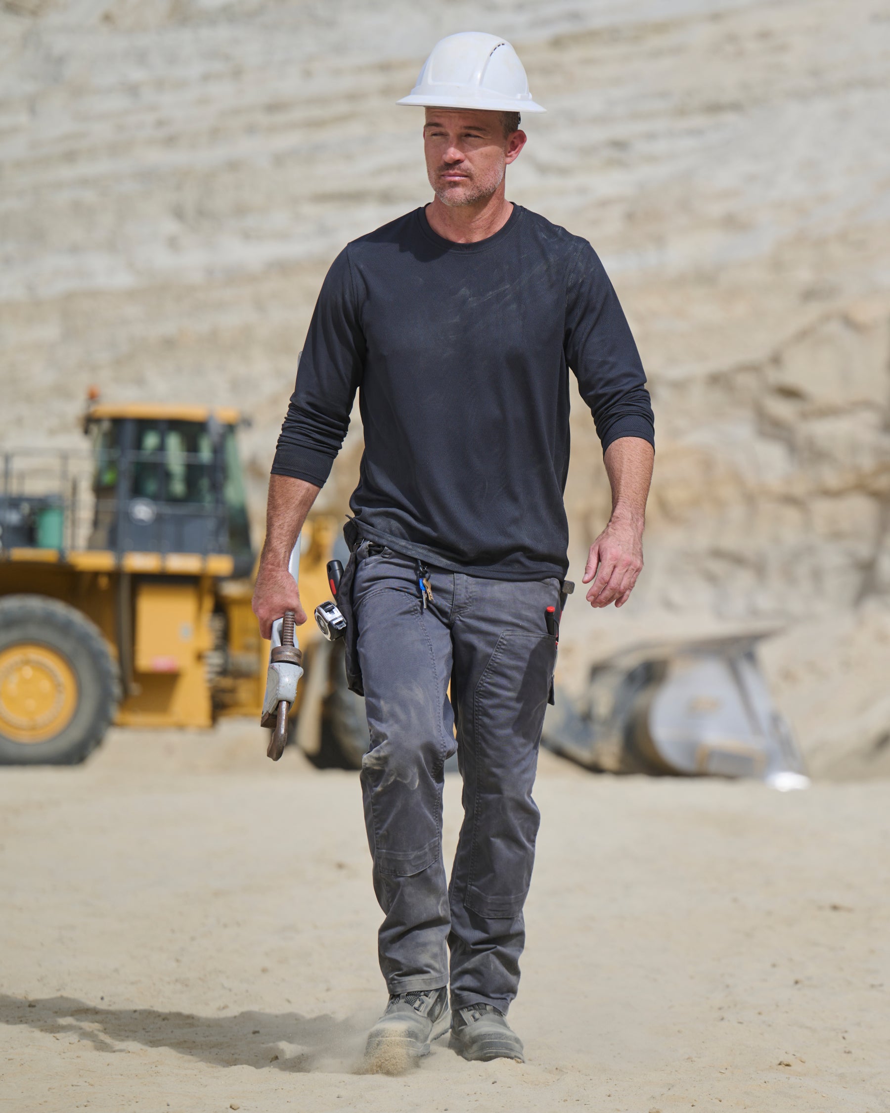 Lifestyle view of Double Front Twill Cargo Work Pants e.s.e:pic in carbon gray during work