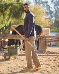 Lifestyle view of Double Front Ripstop Cargo Work Pants e.s.e:pic in almond brown during work