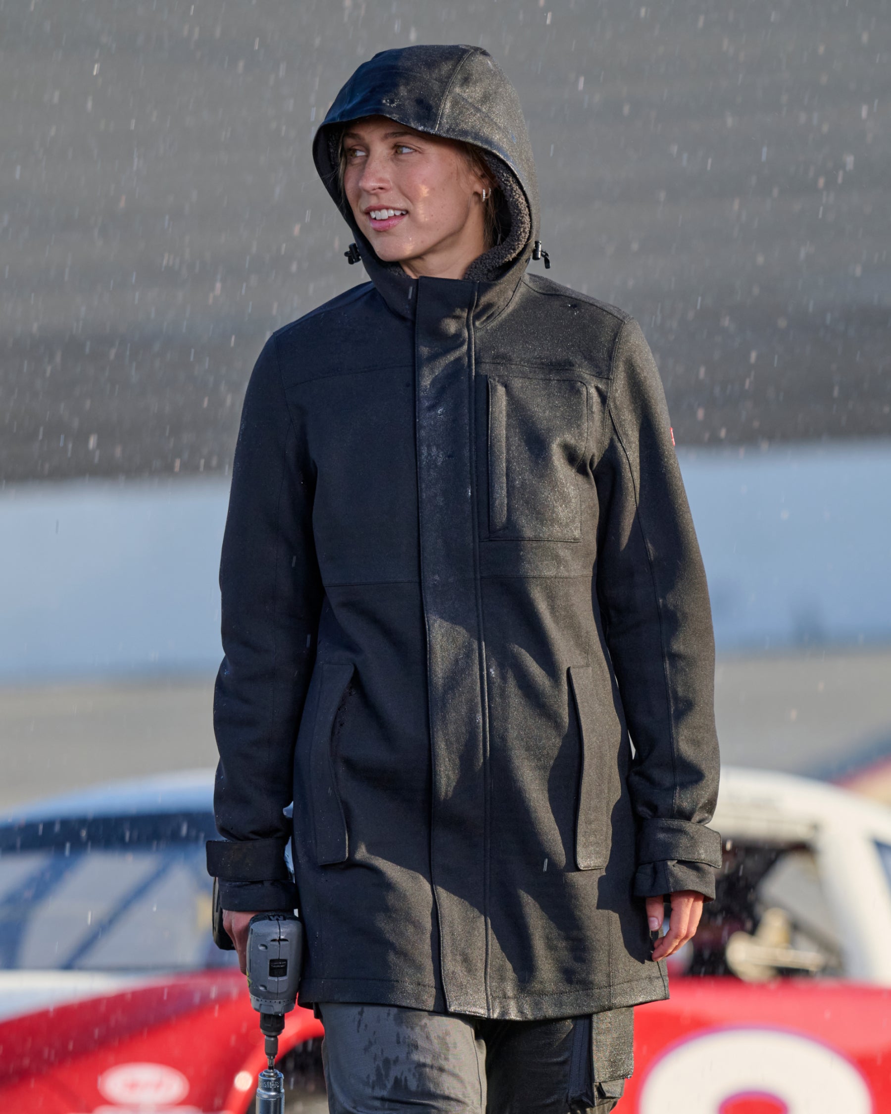 STRAUSS women's e.s.e:pic waterproof rain coat in black worn in a work setting