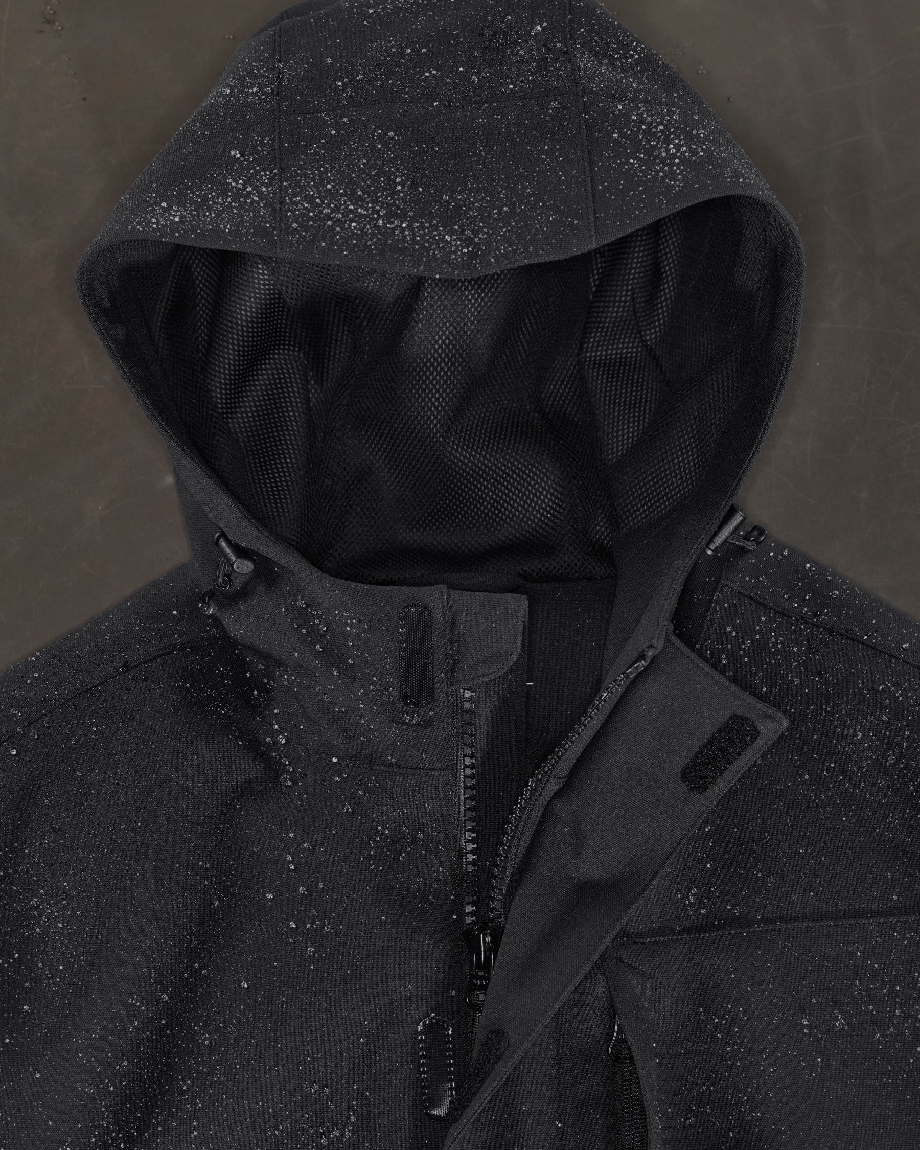 Close-up of waterproof shell and hood details on STRAUSS women's e.s.e:pic waterproof rain coat in black