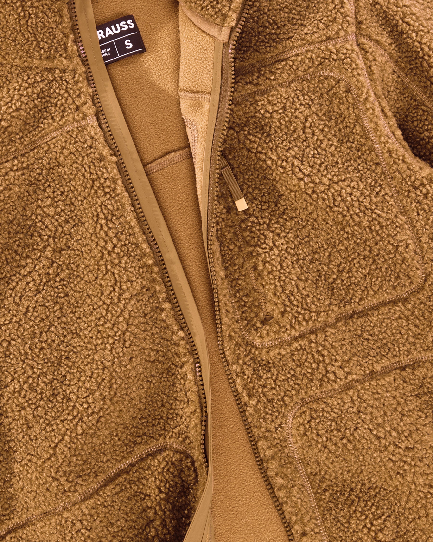 Close-up of sherpa fleece texture and hood details on STRAUSS women's e.s.e:pic hooded sherpa fleece jacket in almond brown