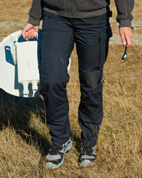 Women's Ripstop Cargo Work Pants e.s.e:pic in black worn in a work setting