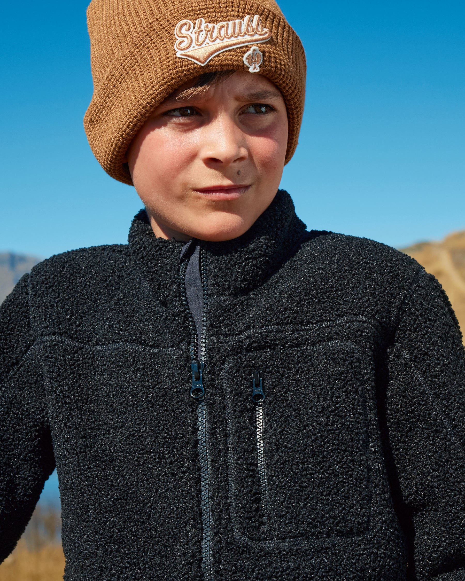 STRAUSS kids' e.s.e:pic sherpa fleece jacket in black paired with workwear