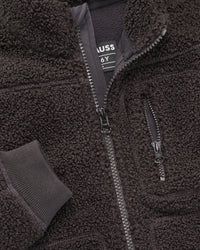 Close-up of sherpa fleece texture and collar details on STRAUSS kids' e.s.e:pic sherpa fleece jacket in black