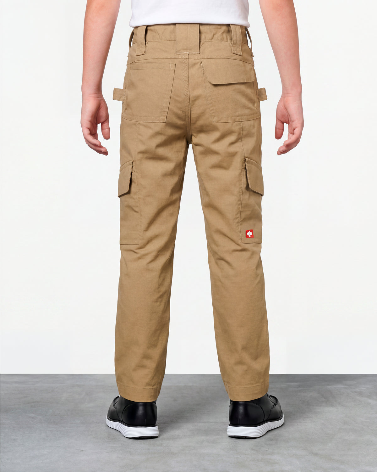 Kids' Double Front Ripstop Cargo Pants e.s.e:pic in almond brown worn by a model, rear view