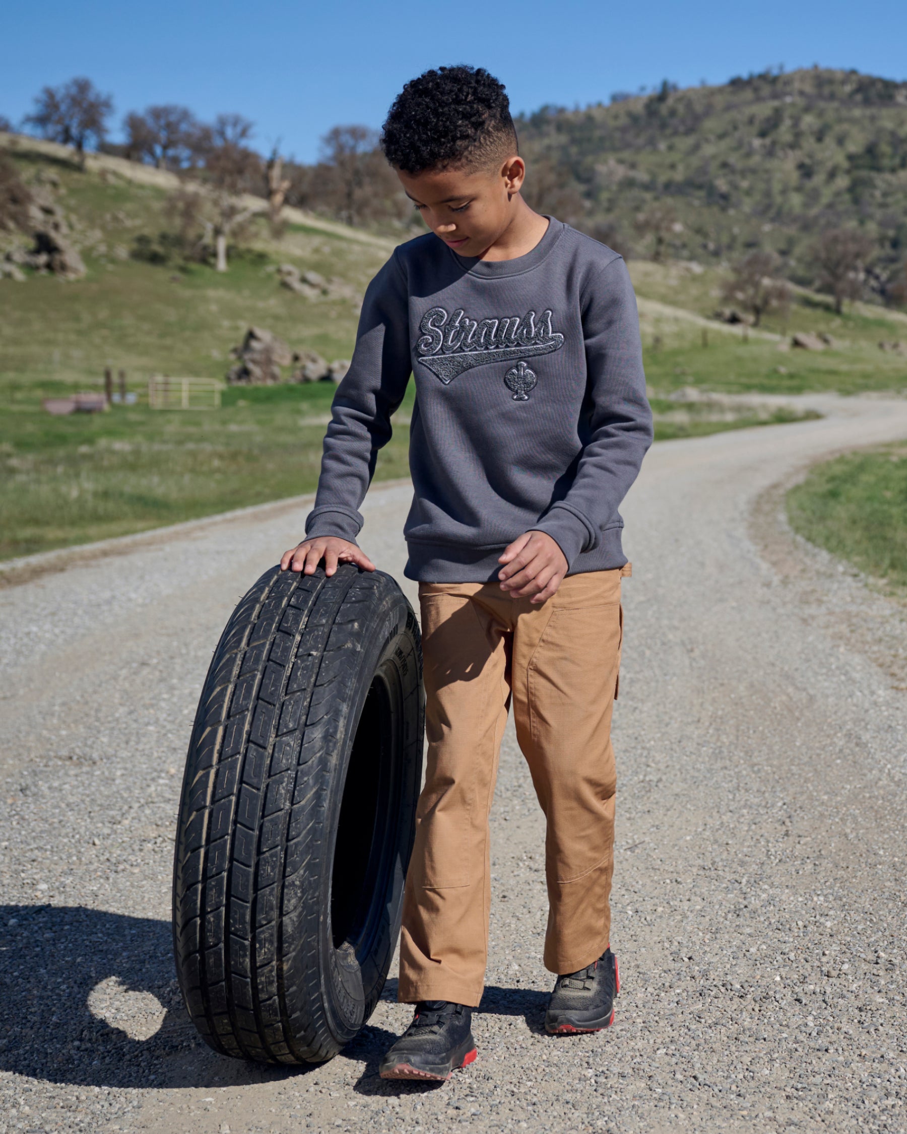 Kids' Double Front Ripstop Cargo Pants e.s.e:pic in almond brown in use, showing fit and movement