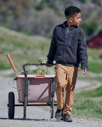 Lifestyle view of Kids' Double Front Ripstop Cargo Pants e.s.e:pic in almond brown during work