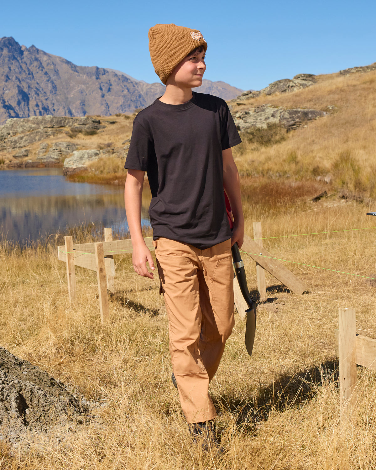 Kids' Double Front Ripstop Cargo Pants e.s.e:pic in almond brown shown in an outdoor workwear setting
