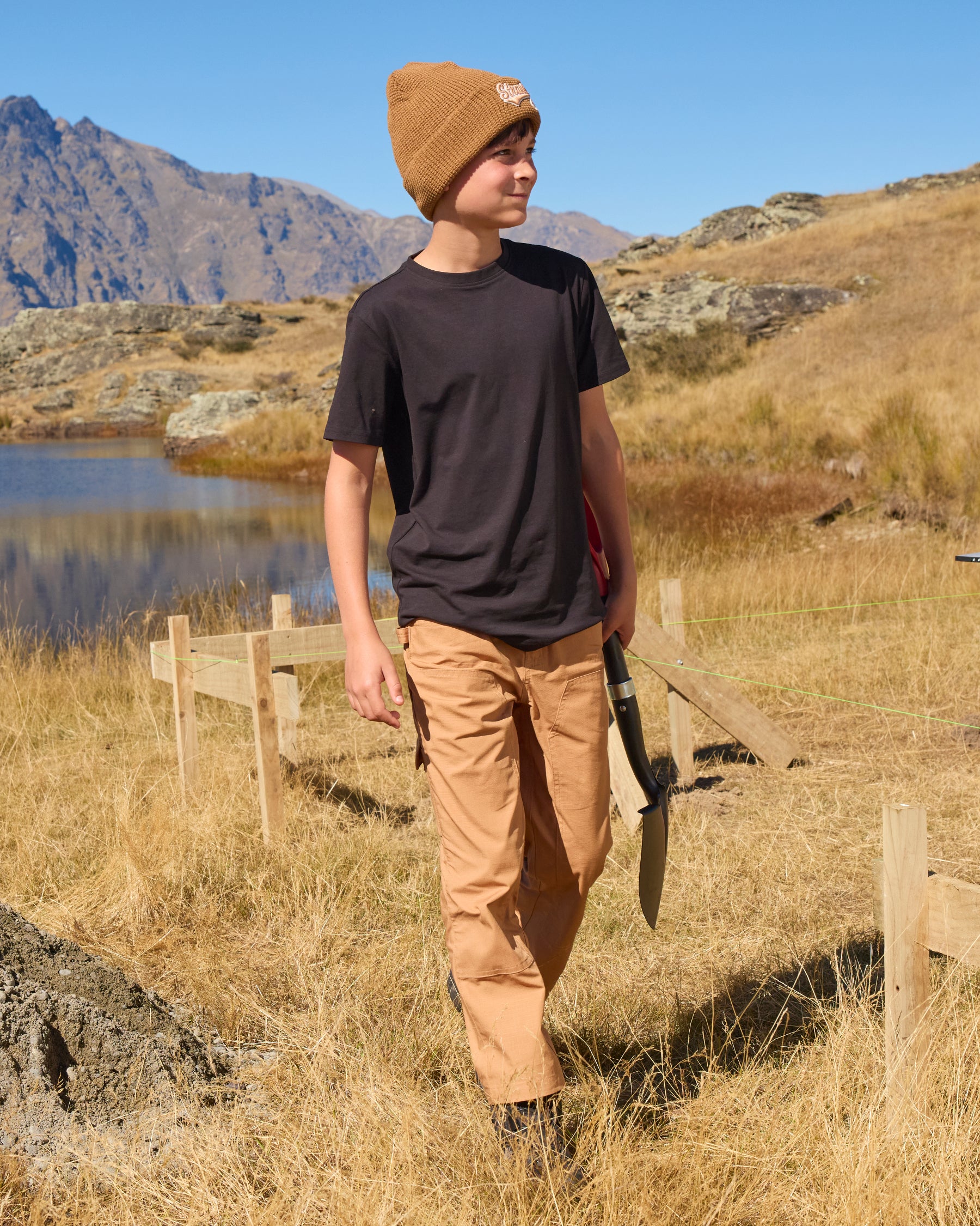 Kids' Double Front Ripstop Cargo Pants e.s.e:pic in almond brown shown in an outdoor workwear setting
