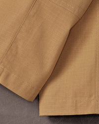 Close-up of reinforced fabric and seams on Kids' Double Front Ripstop Cargo Pants e.s.e:pic in almond brown