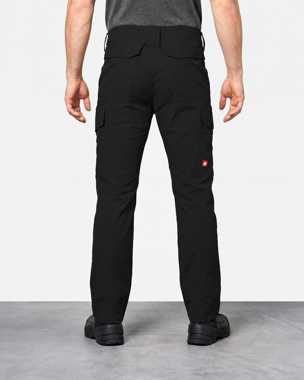 Stretch Ripstop Cargo Work Pants e.s.taktik in black worn by a model, rear view