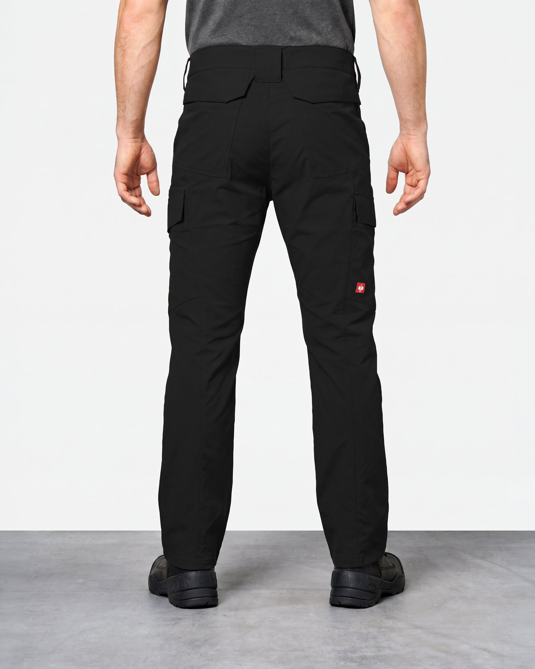 Stretch Ripstop Cargo Work Pants e.s.taktik in black worn by a model, rear view