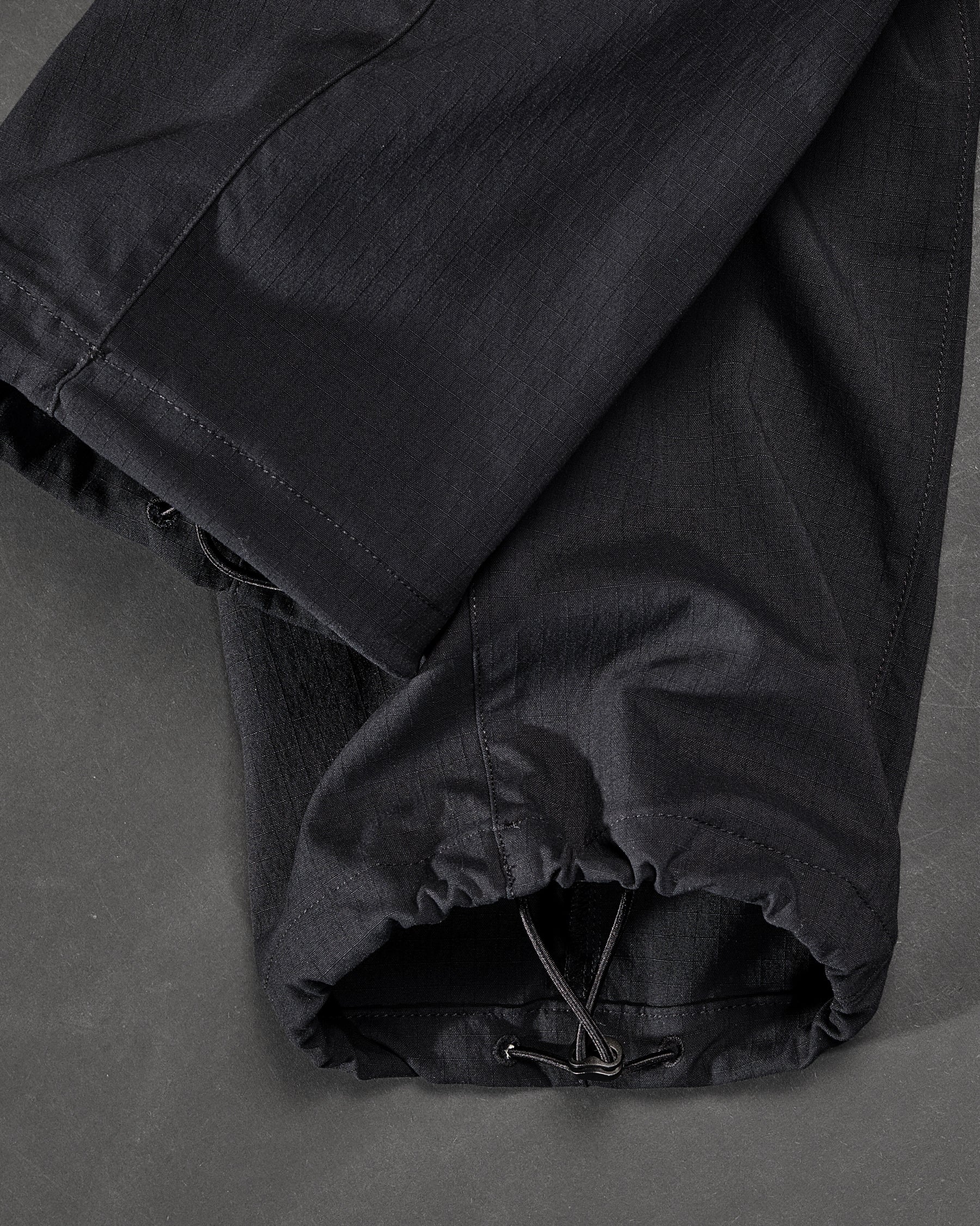 Close-up of adjustable hem pocket details on Stretch Ripstop Cargo Work Pants e.s.taktik in black