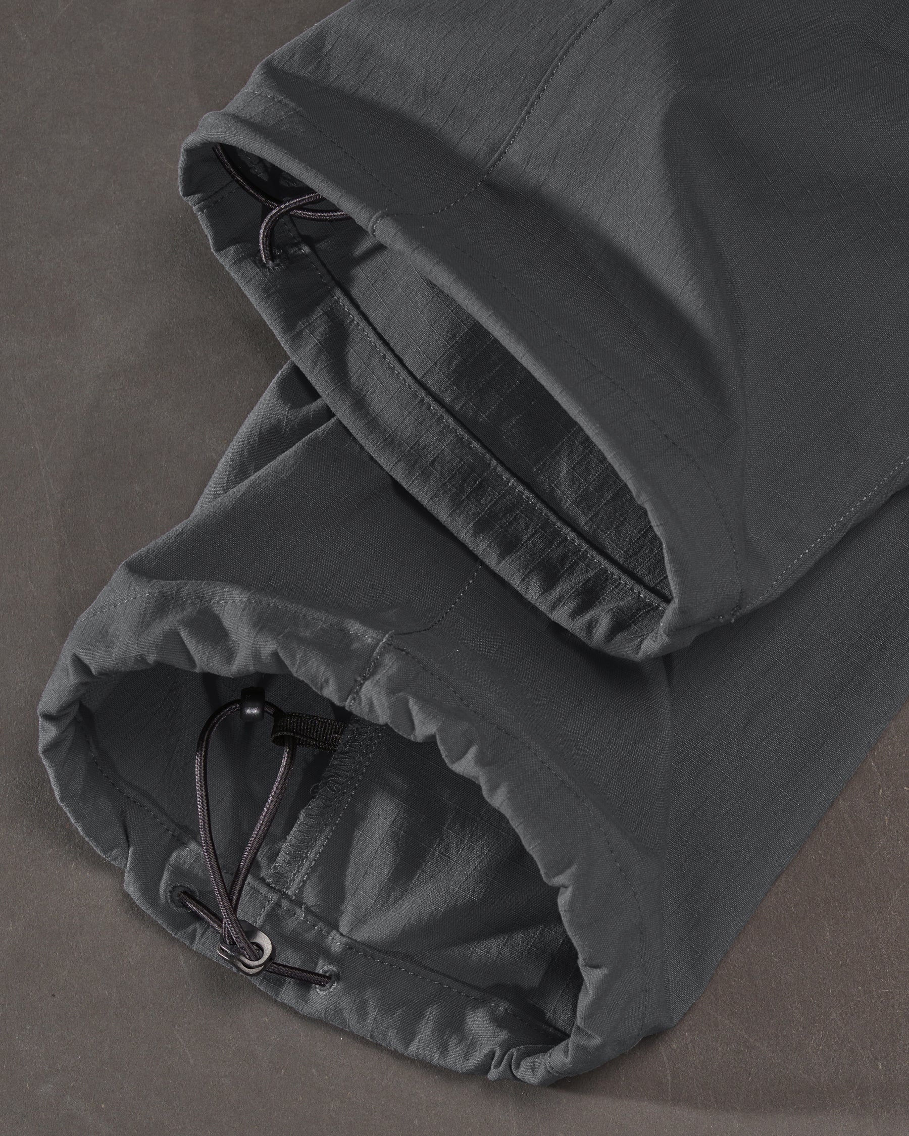 Close-up of adjustable hem details on Stretch Ripstop Cargo Work Pants e.s.taktik in carbon gray