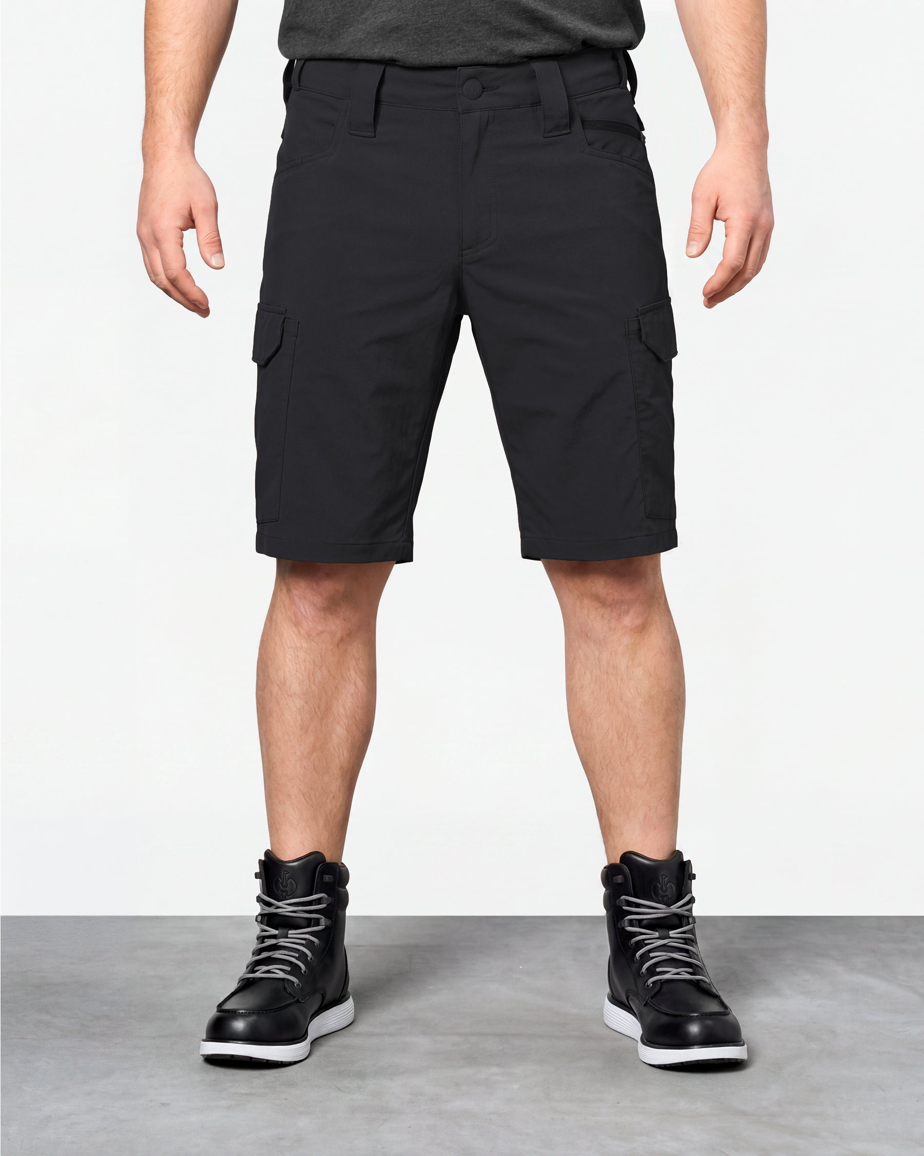 Model wearing Engelbert Strauss e.s. taktik stretch ripstop cargo work shorts in black, showing the fit, length, waistband, and front pocket layout of the durable stretch ripstop cargo work shorts with utility pockets.