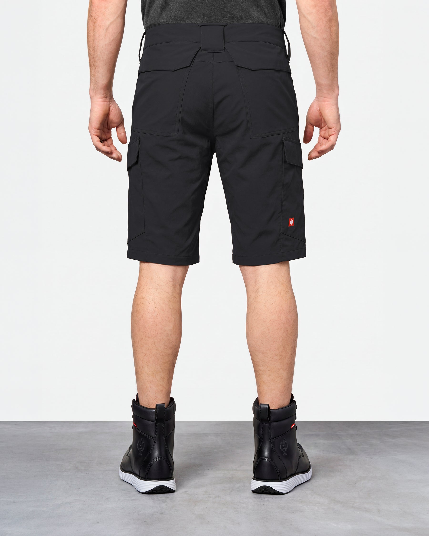 Alternate model view of Engelbert Strauss e.s. taktik stretch ripstop cargo work shorts in black, showing the side and back fit with visible utility pocket placement and workwear construction.