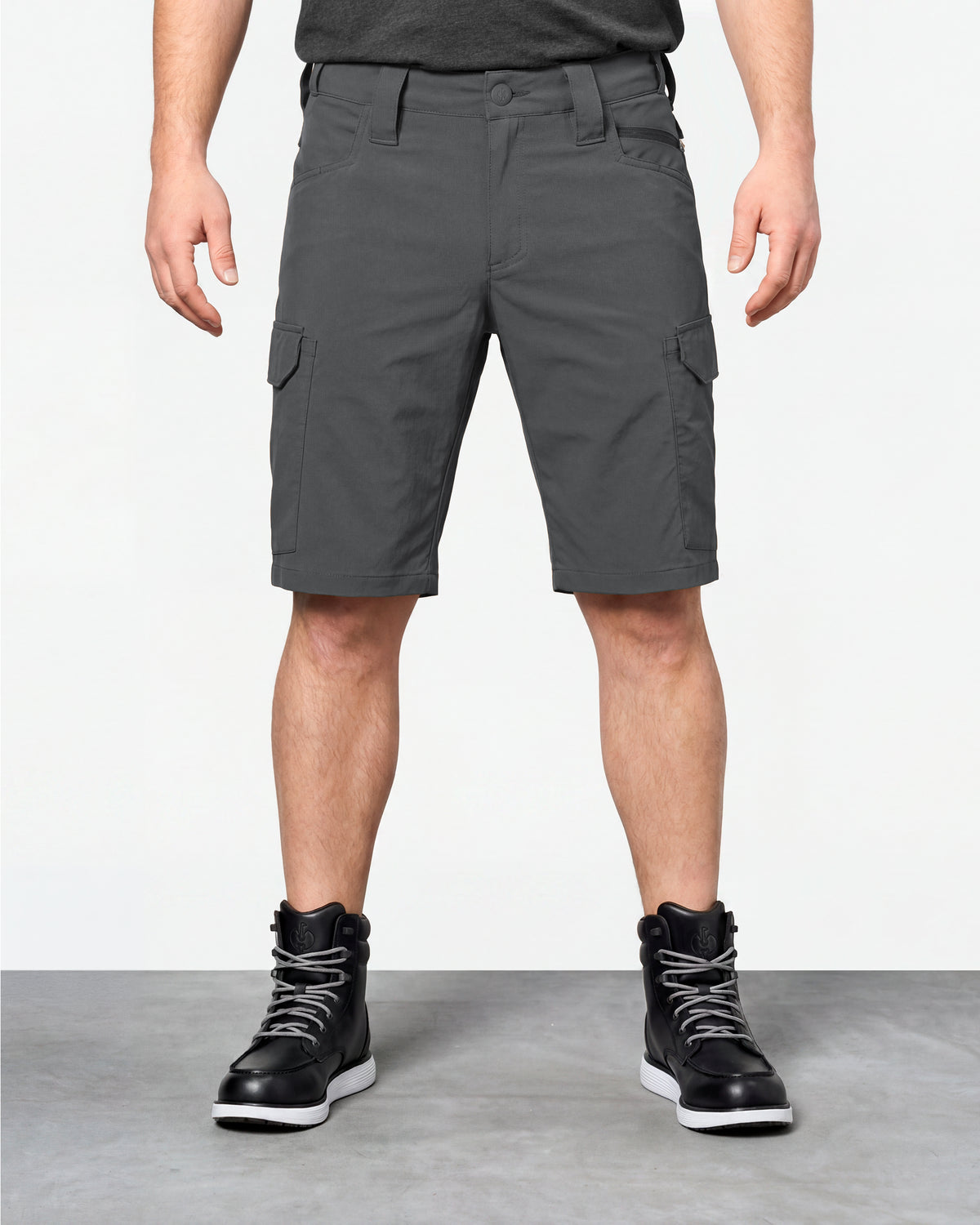 Model wearing Engelbert Strauss e.s. taktik stretch ripstop cargo work shorts in carbon gray, showing the fit, length, waistband, and front pocket layout of the durable stretch ripstop cargo work shorts with utility pockets.