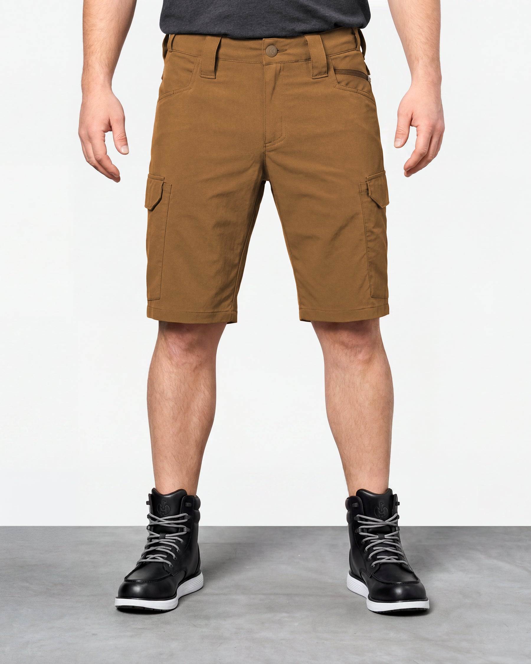 Model wearing Engelbert Strauss e.s. taktik stretch ripstop cargo work shorts in desert brown, showing the fit, length, waistband, and front pocket layout of the durable stretch ripstop cargo work shorts with utility pockets.
