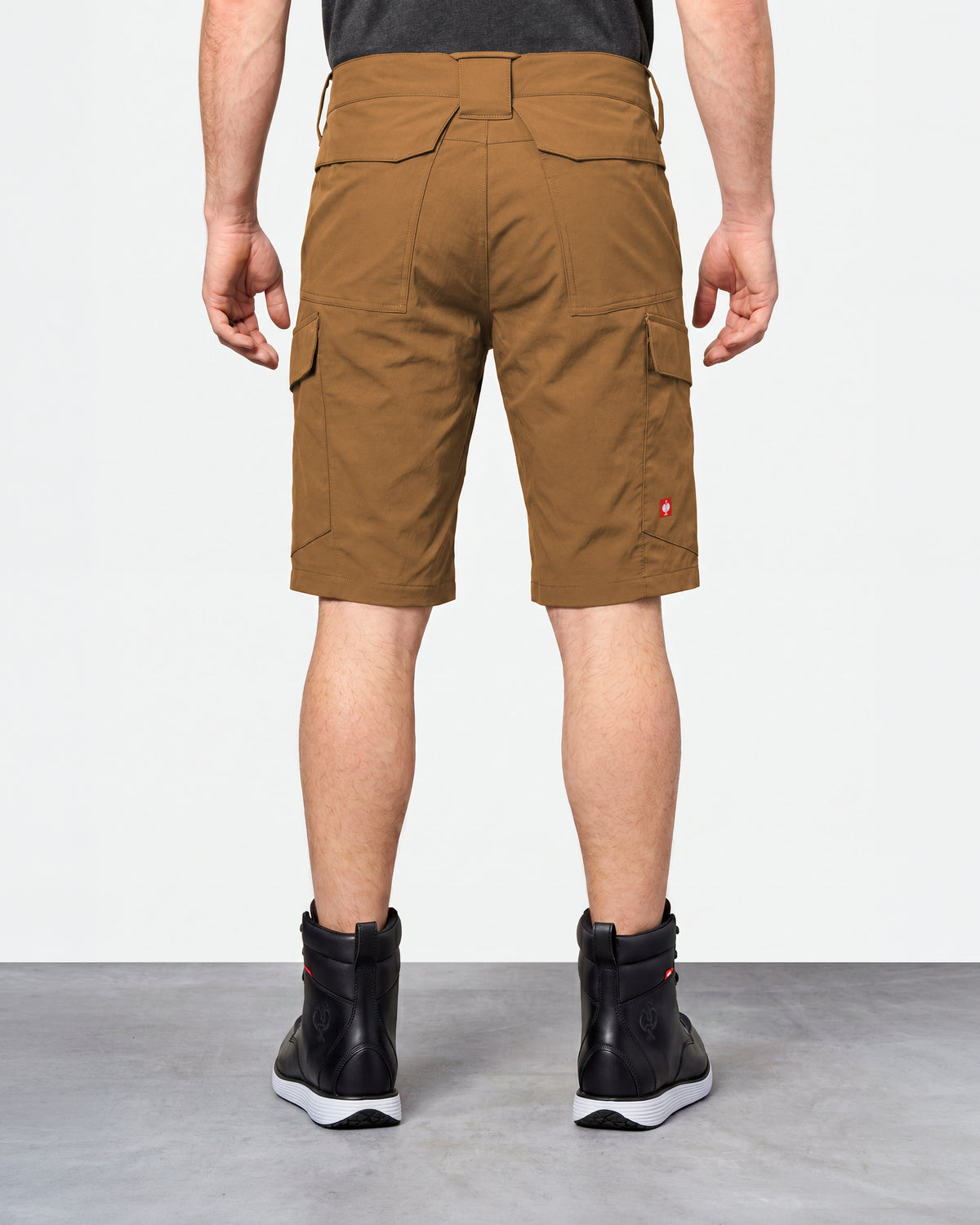 Alternate model view of Engelbert Strauss e.s. taktik stretch ripstop cargo work shorts in desert brown, showing the side and back fit with visible utility pocket placement and workwear construction.