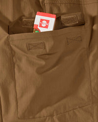 Close-up detail of Engelbert Strauss e.s. taktik stretch ripstop cargo work shorts in desert brown, focusing on the utility pocket area, seams, and reinforced workwear construction.